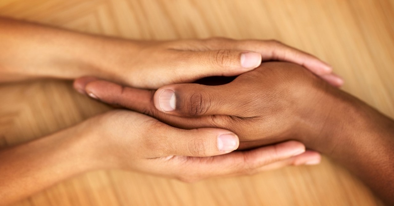 couple holding hands, ways that normalization of anxiety can hurt and ways that it can help