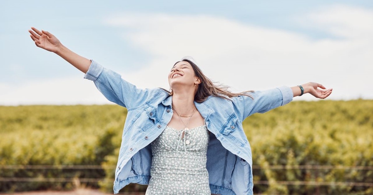 Happy, joyful woman with arms outstretched