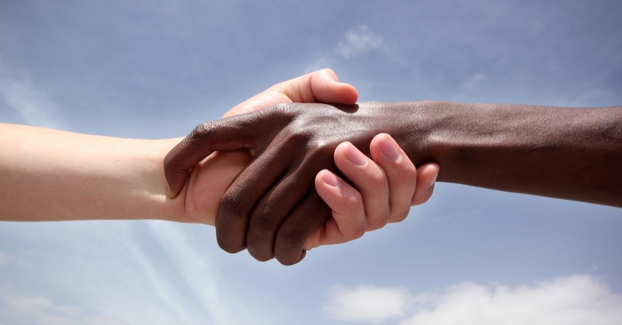 white man holding black man's hand to illustrate racial reconciliation Will D. Campbell christian writer activist civil rights