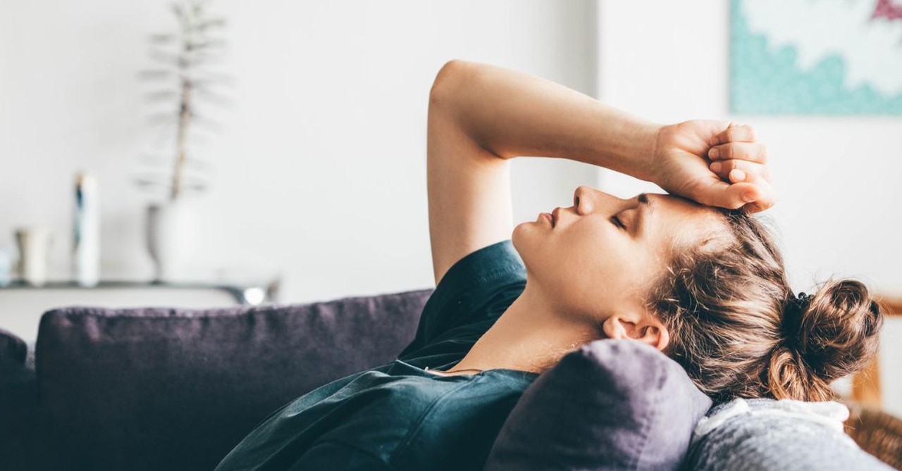 Woman with hand on her head; the devastating impact of an affair.