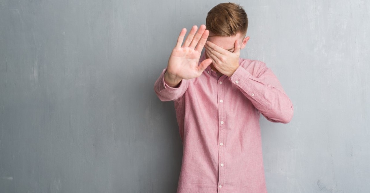 man covering his eyes hands held up to say stop, prayers that real men pray