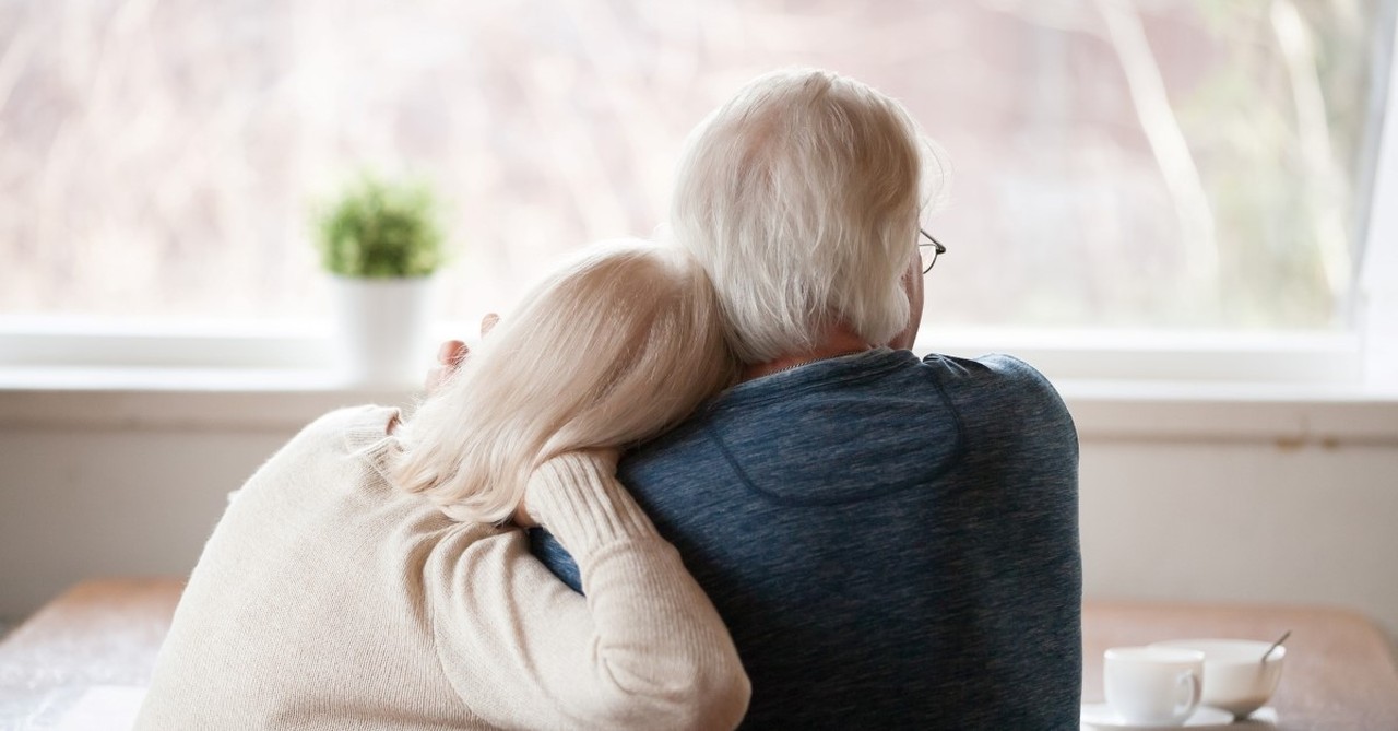 older couple hugging while looking out door, biblical truths for a fulfilling sex life