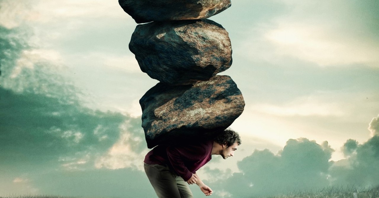 man carrying a stack of heavy rocks to illustrate god won't give you more than you can handle things you never say to someone during a crisis