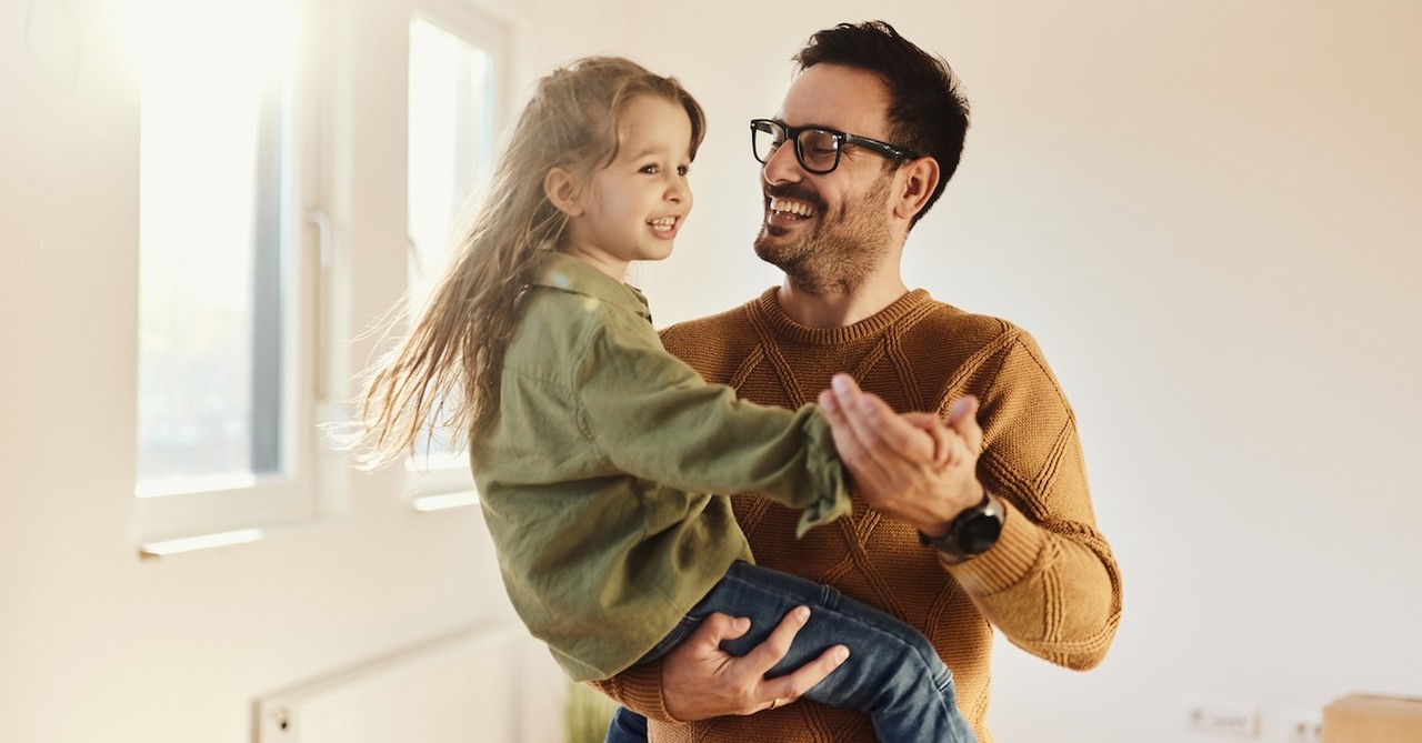 Father and daughter dancing happy child with dad