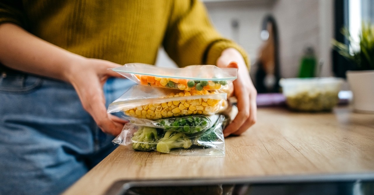 Woman packing bags of leftover food