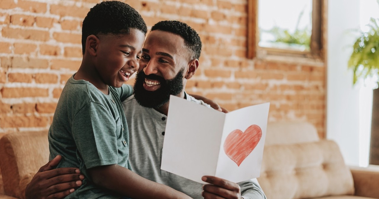 Son giving dad card with heart Father's Day gift