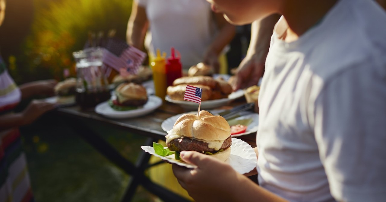 Boy eating burger 4th fourth of july cookout