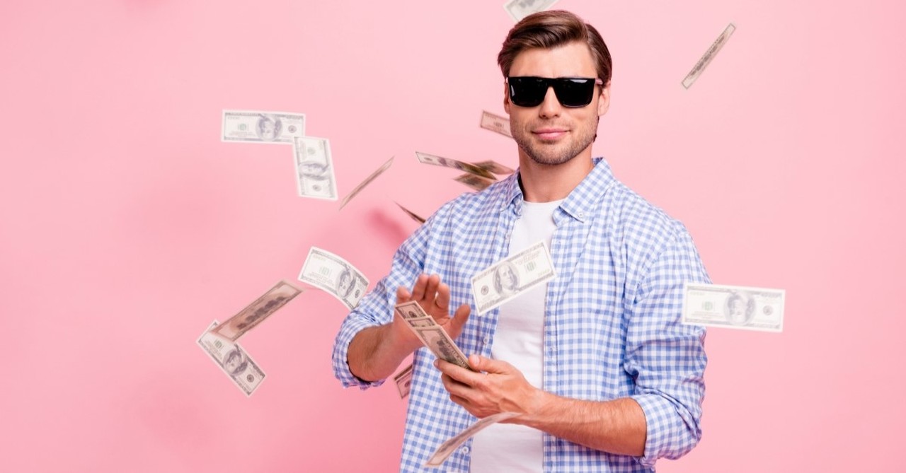 man wearing sunglasses throwing hundred-dollar bills into the air, warning signs of a narcissistic pastor