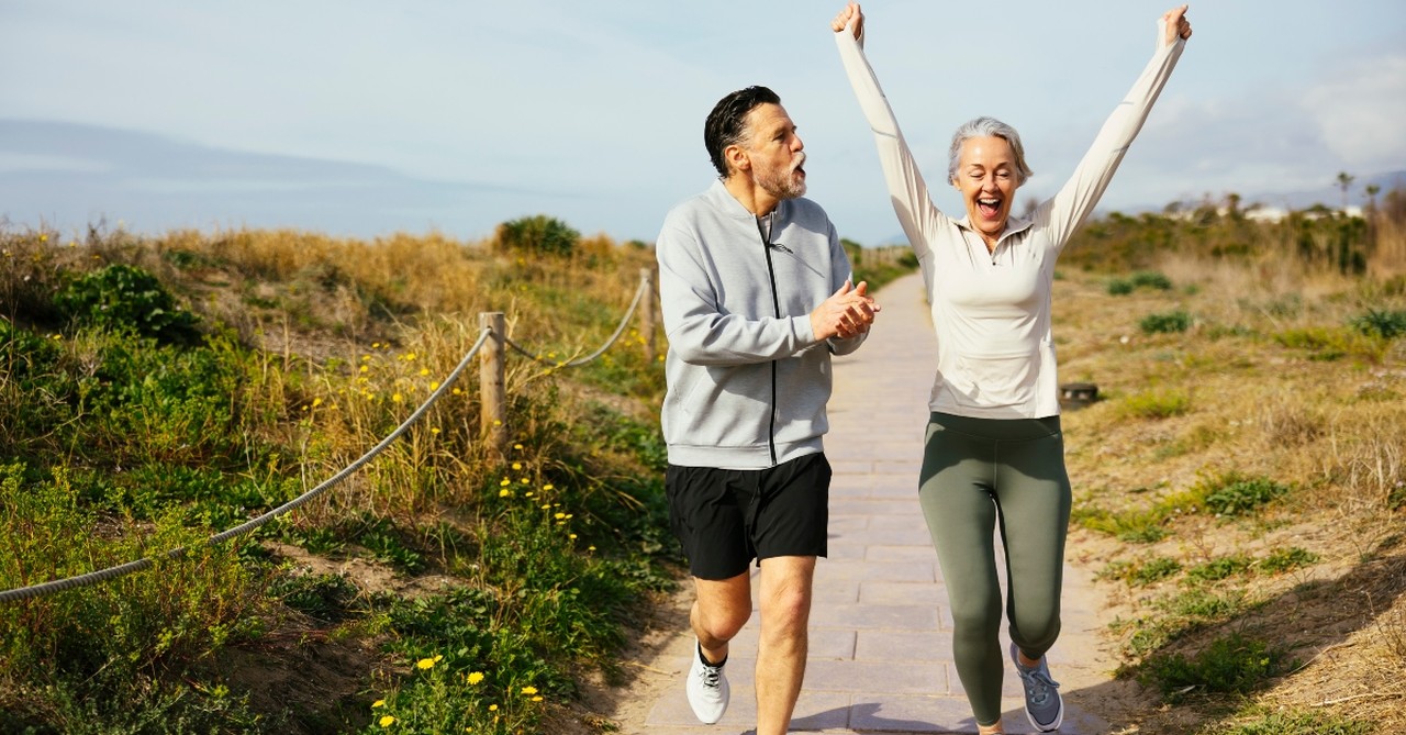 Man cheering for a woman who's jogging