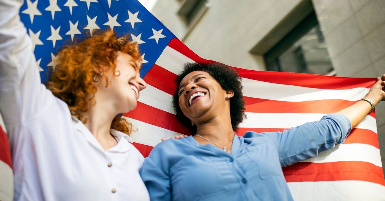 Two women with an American flag; can we love both God and country?