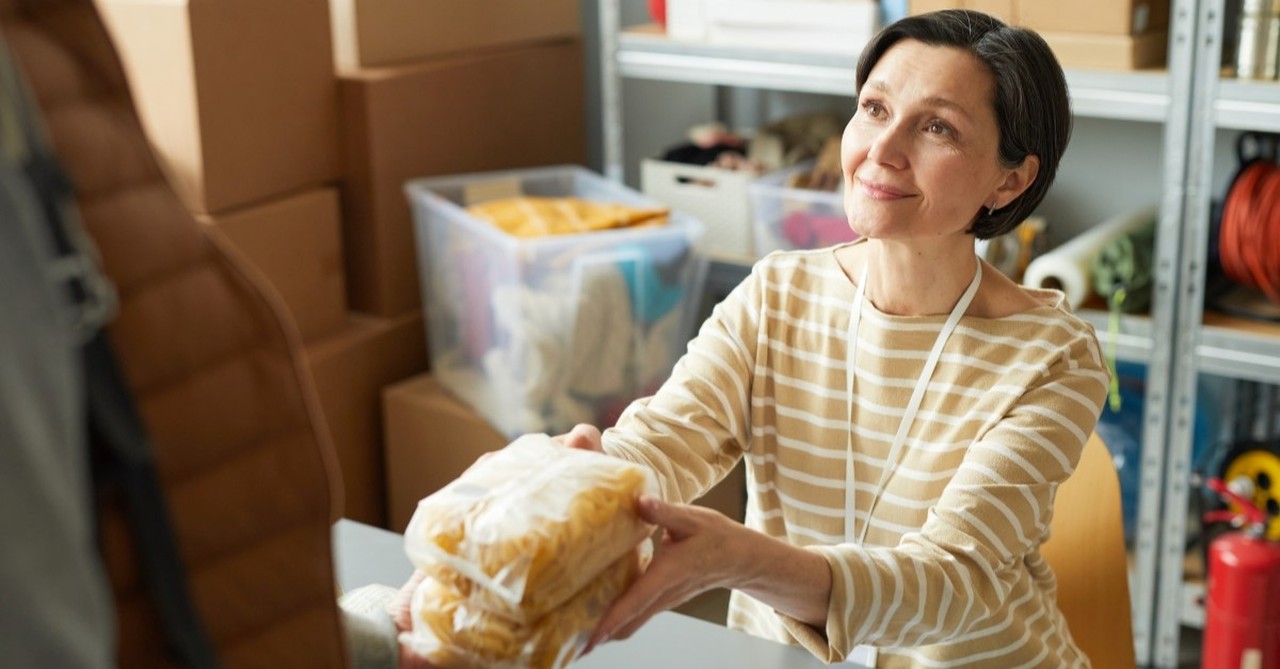 woman giving out food at food pantry, reasons why women are vital to church community