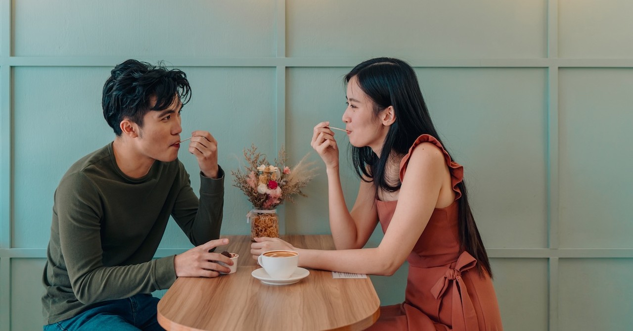 Cute couple on first date at cafe eating