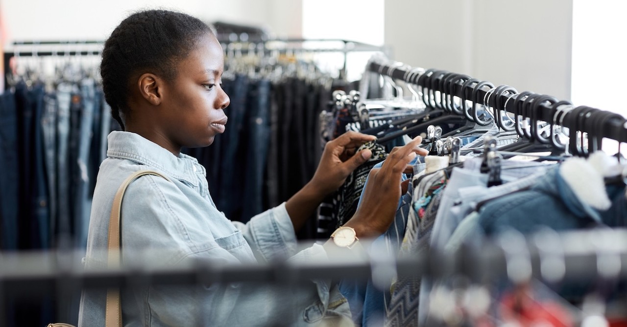 Woman thrifting shopping for clothes store