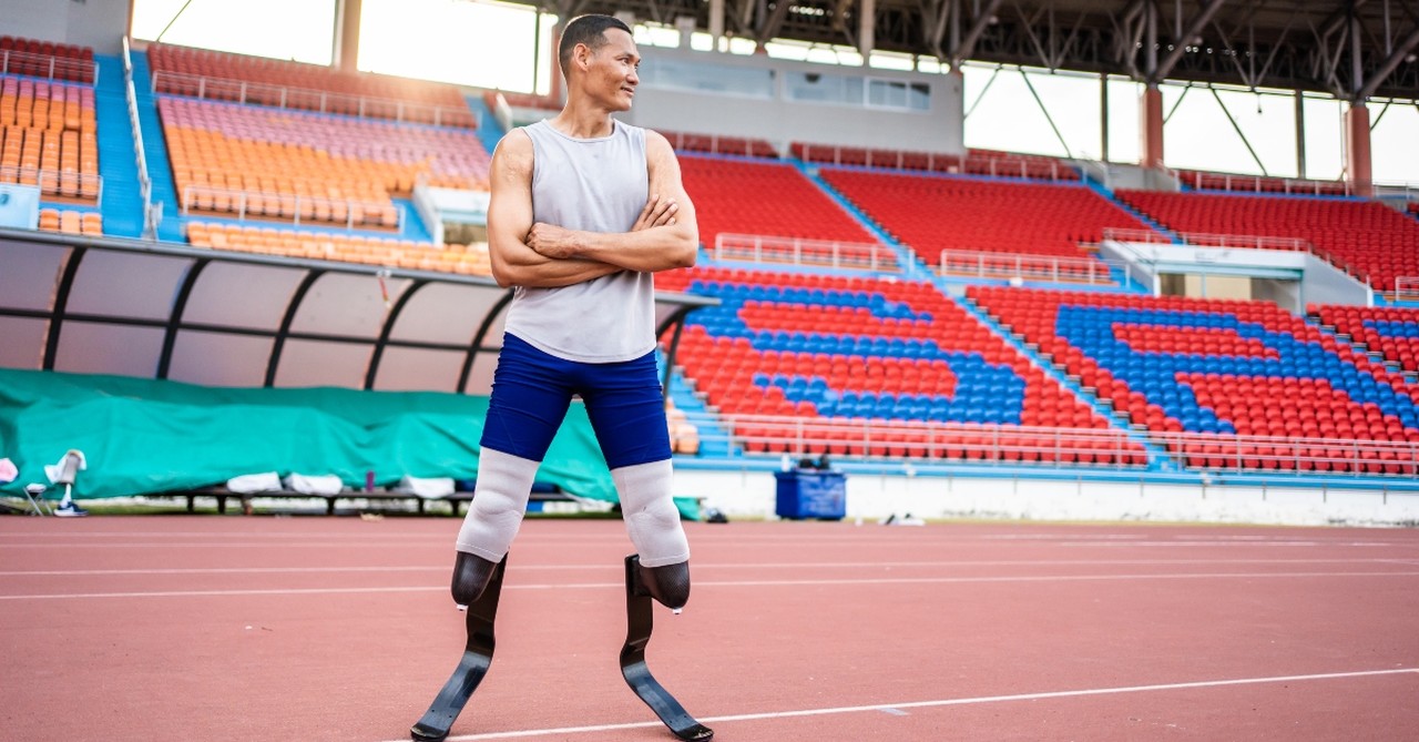 A man with two prosthetic legs, preparing to run a race