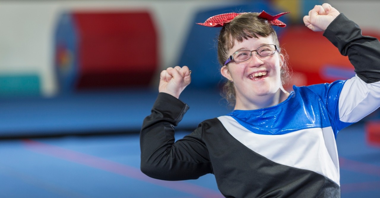 A young woman with Down's syndrome, celebrating after gymnastics routine