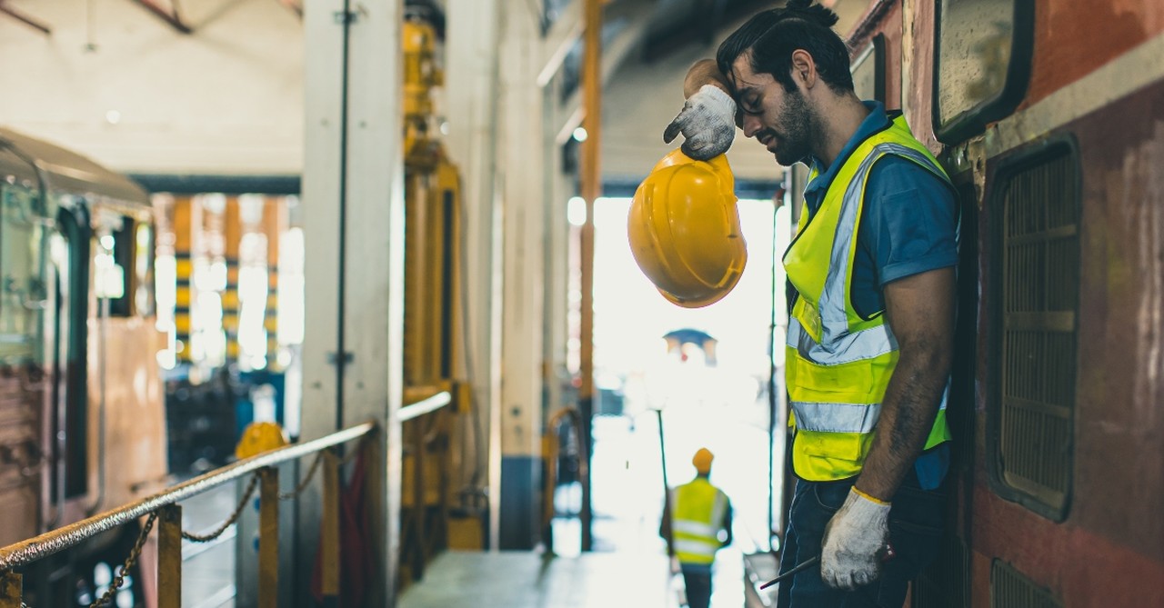 A tired construction worker taking a break