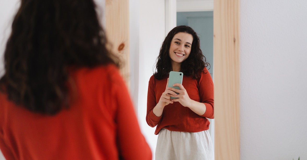 woman looking in mirror