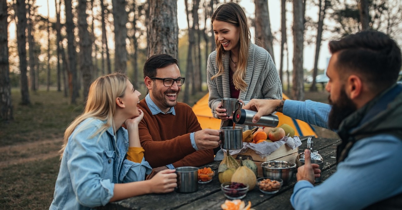 Group of friends eating outside fall leaves picnic autumn