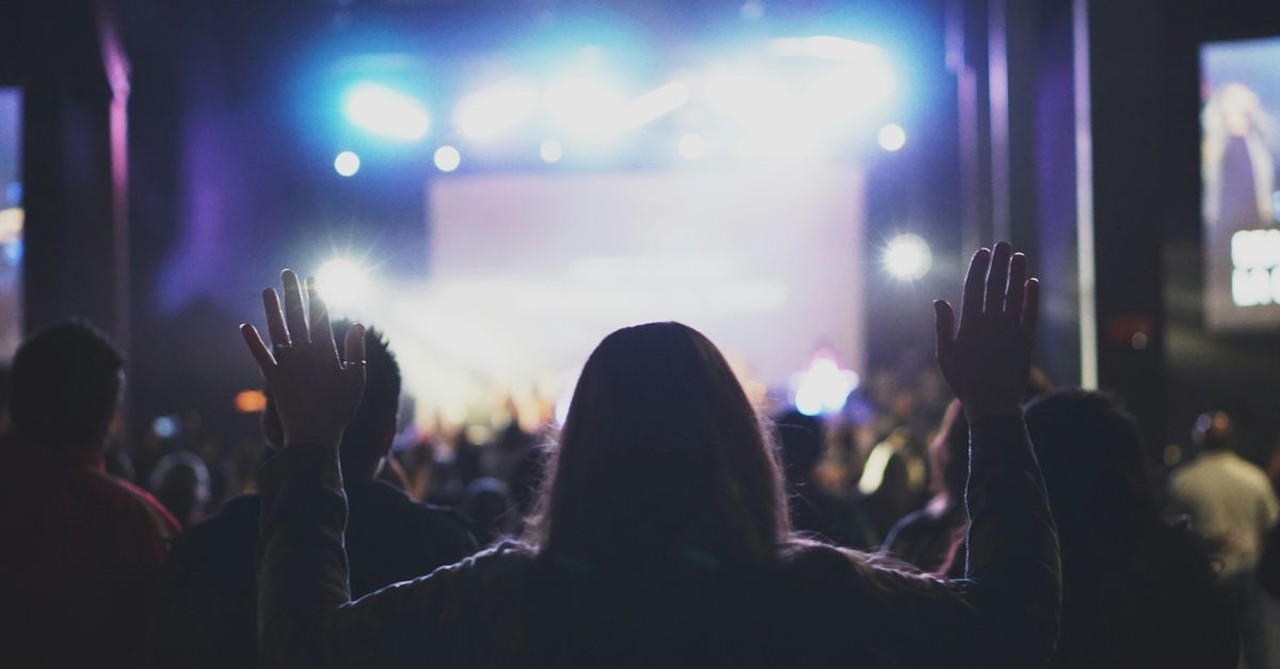 Woman worshipping at church; what to do when you're bored at church.