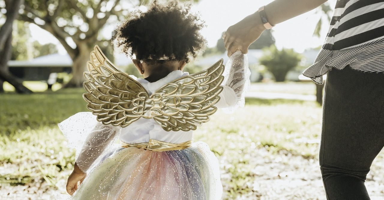 Girl dressed up as angel Halloween costume trick or treating