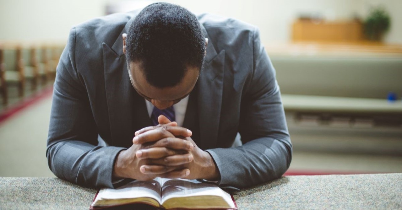 pastor church pew preacher prayer kneeling bible