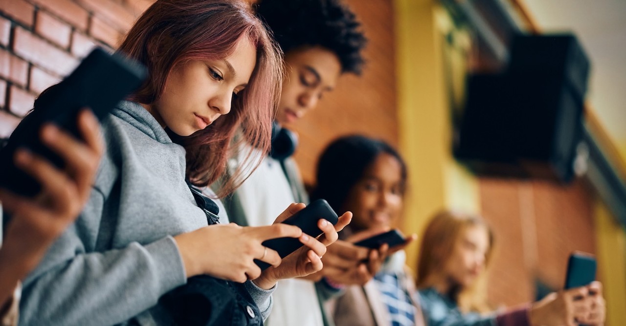 Teenagers at school on cell phones