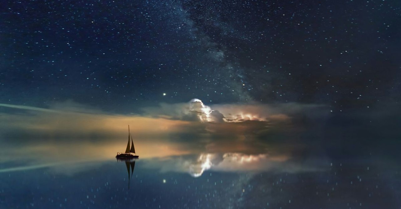 Sailboat on the water at night