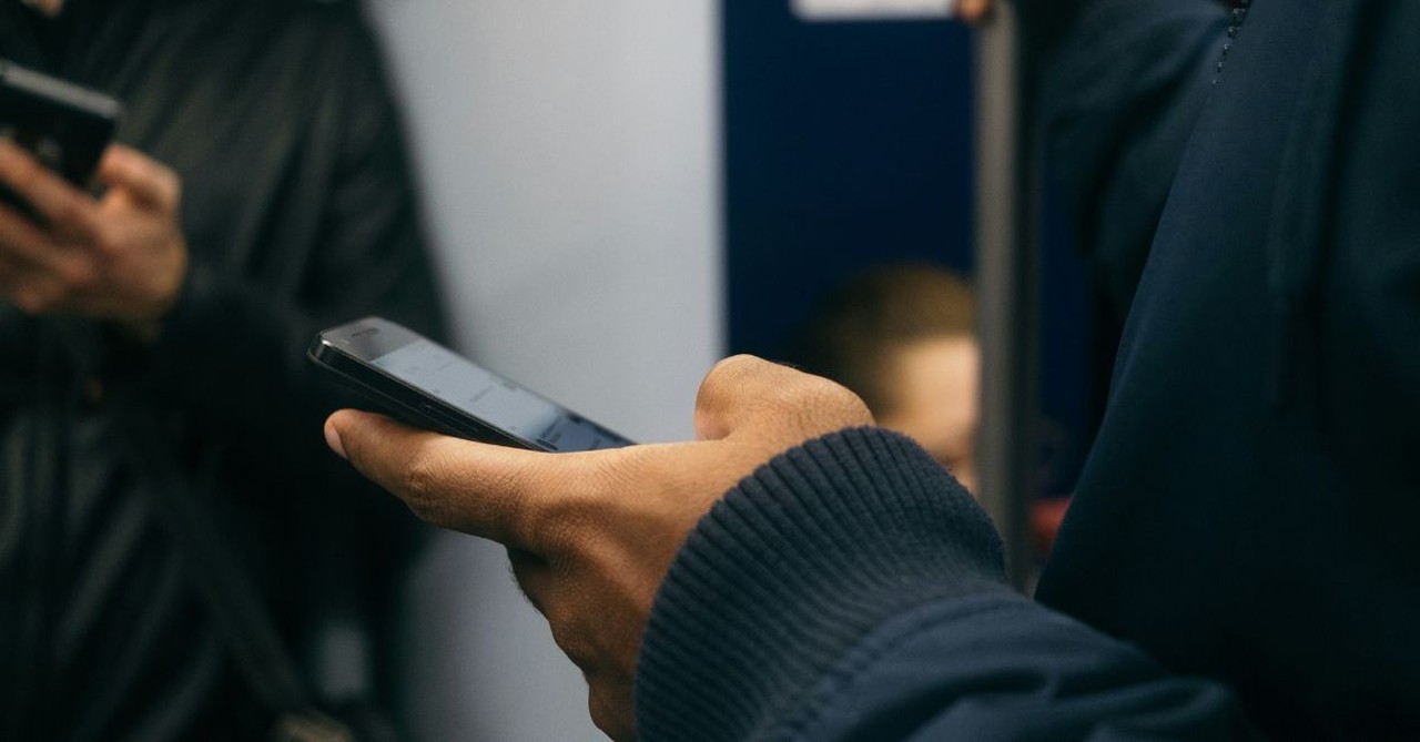 Man scrolling on his phone.