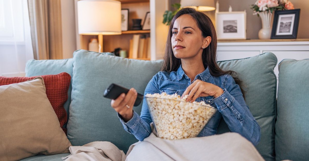 Woman watching television; tv; movie and popcorn