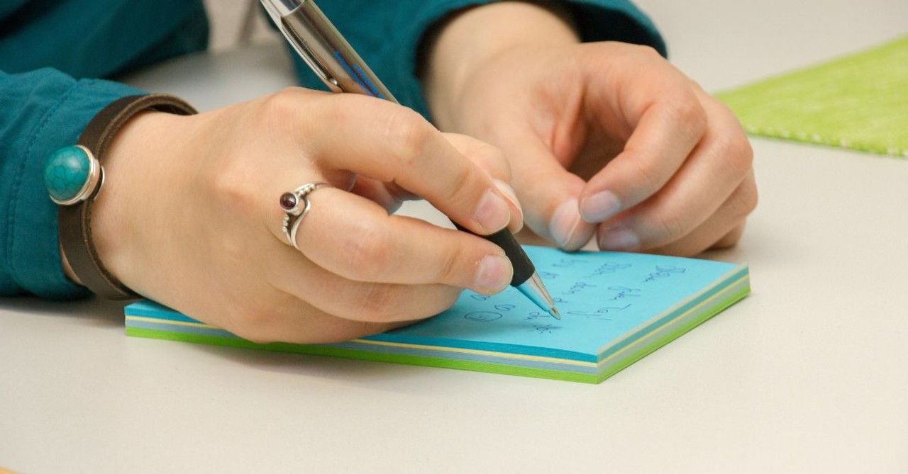 Woman writing a note; how to find a spiritual mentor