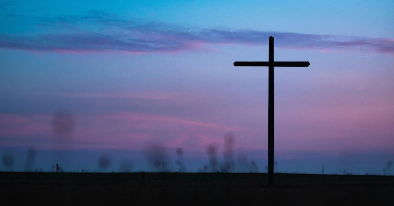 Silhouette of a cross at sunrise; meditations of The Last Supper