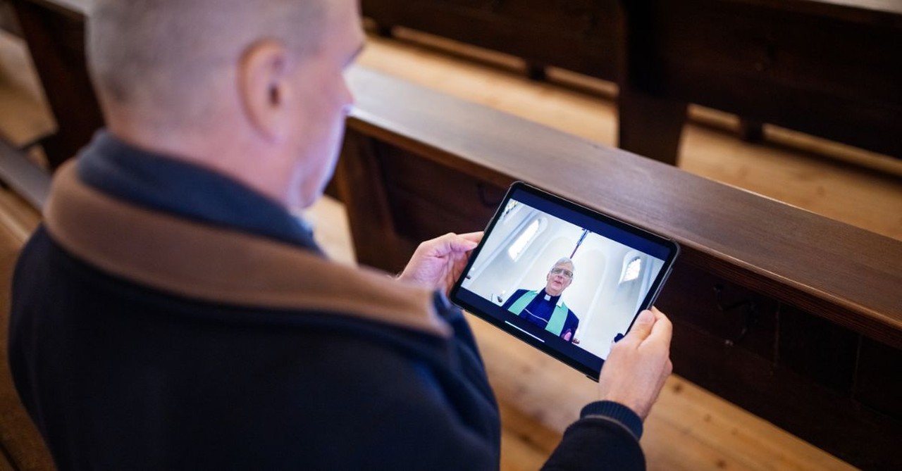 Pastor watching YouTube video on Ipad; Priest with Ipad