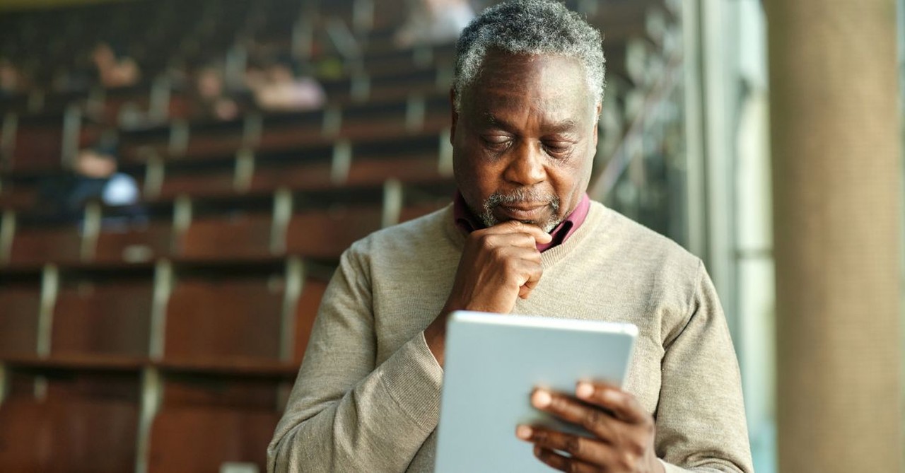 Pastor reading digital bible; pastor with Ipad