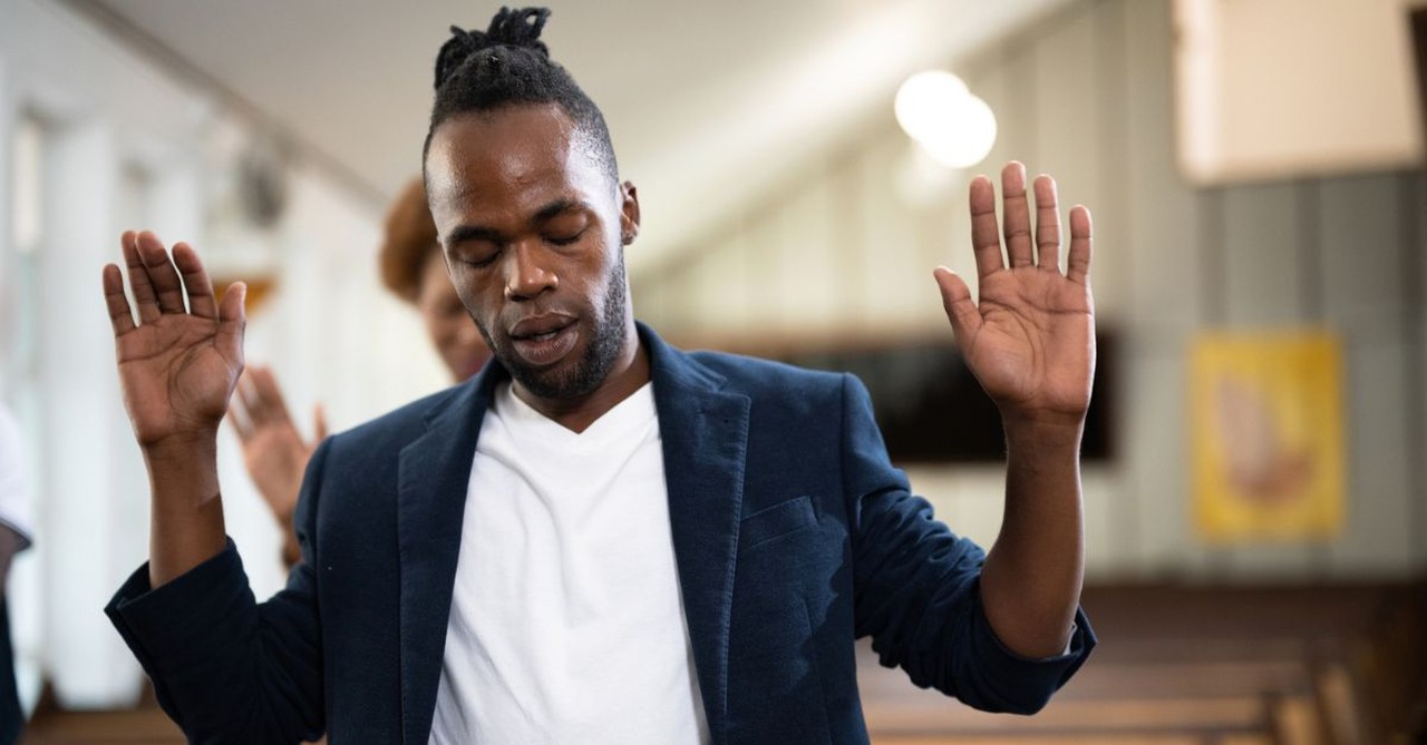 pastor worshipping; hands in air; praise