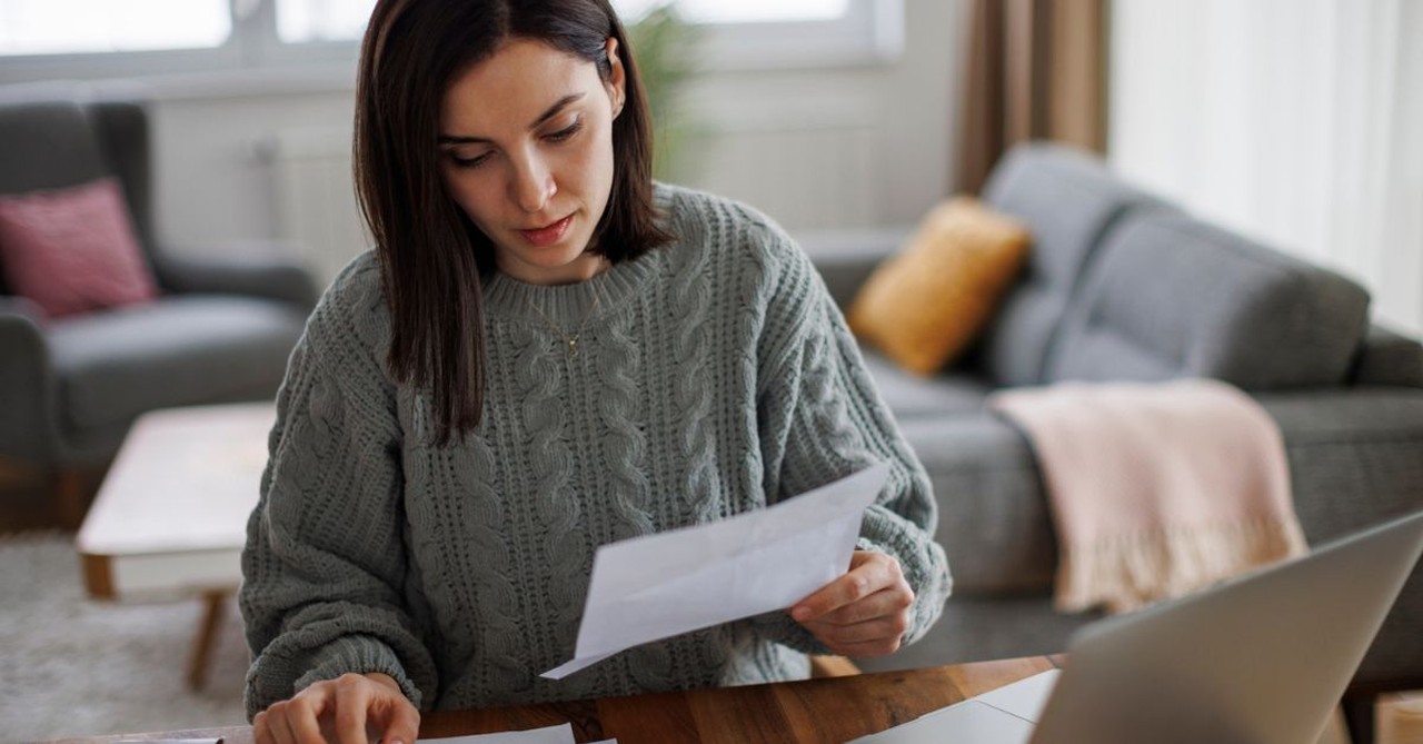 Paying off student loans; woman calculating finances; financial planning