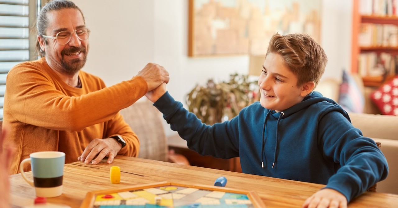 Father and son playing game board game