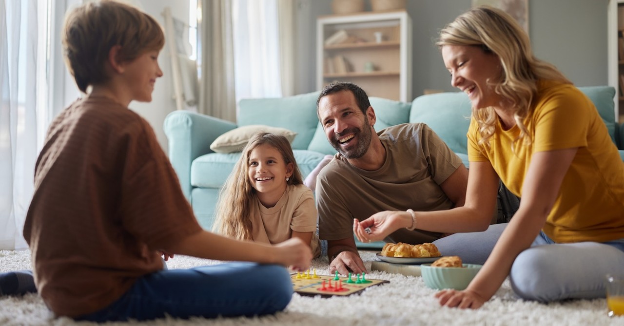 Family playing boardgame game night