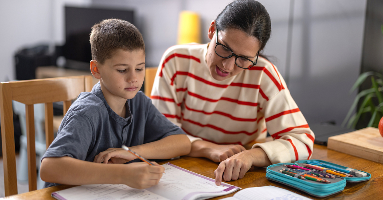 Parent reviewing a schoolbook with a child