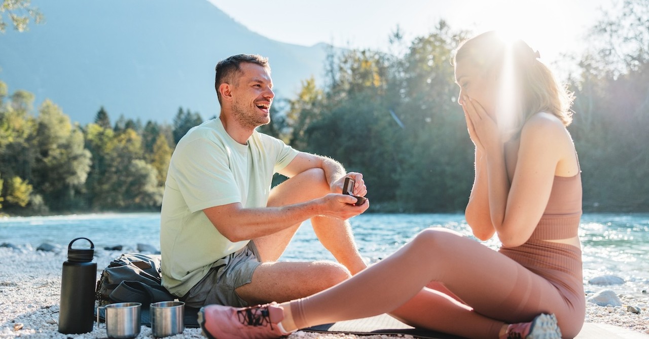 Man proposing on hike nature mountains engagement proposal
