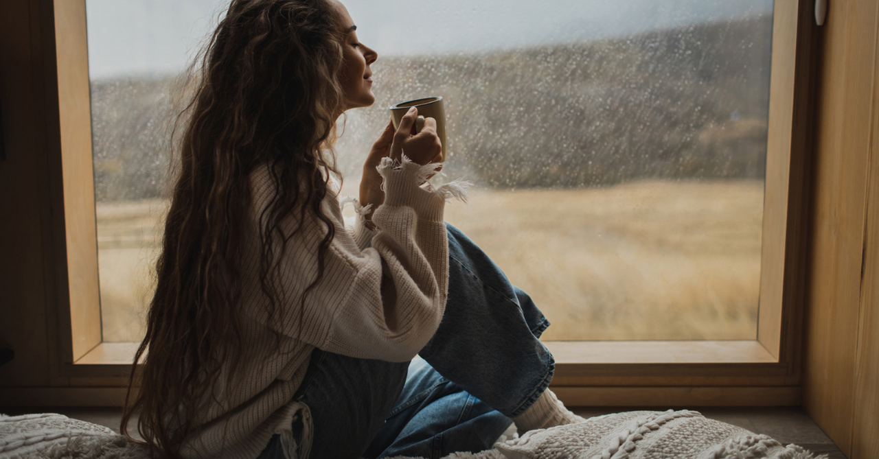 a woman with a peaceful, joyful expression on a gloomy day