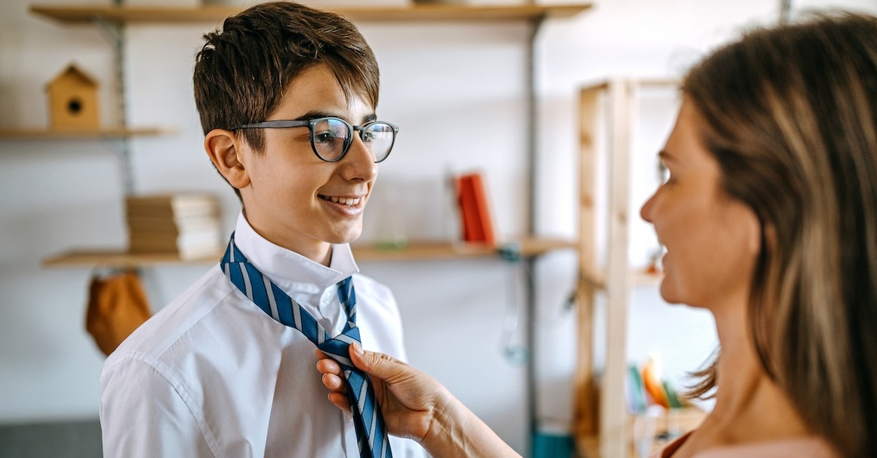 Mom helping teen son get dressed ready body image