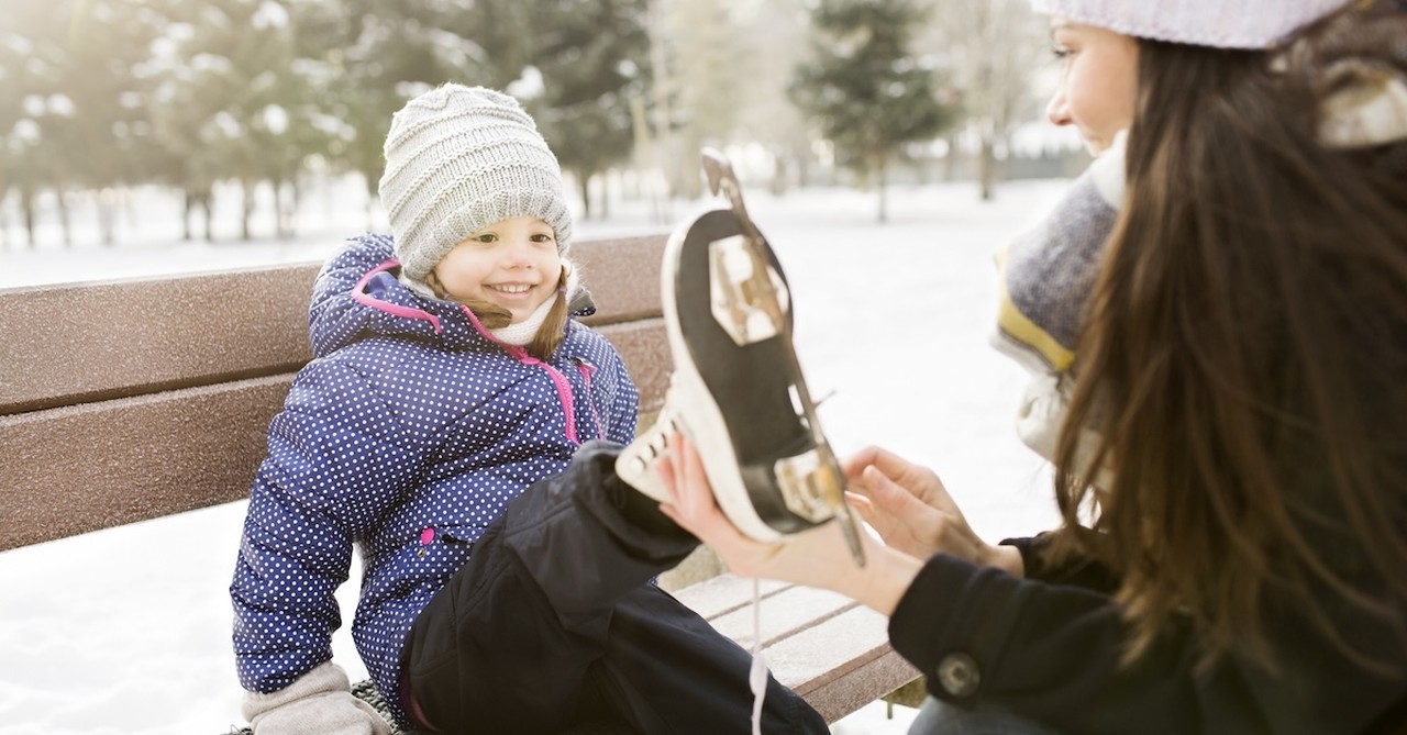 Mom and daughter ice skating winter activity snow