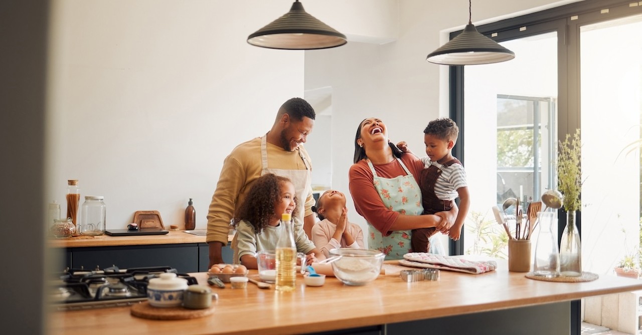 Family in kitchen cooking parent and kids
