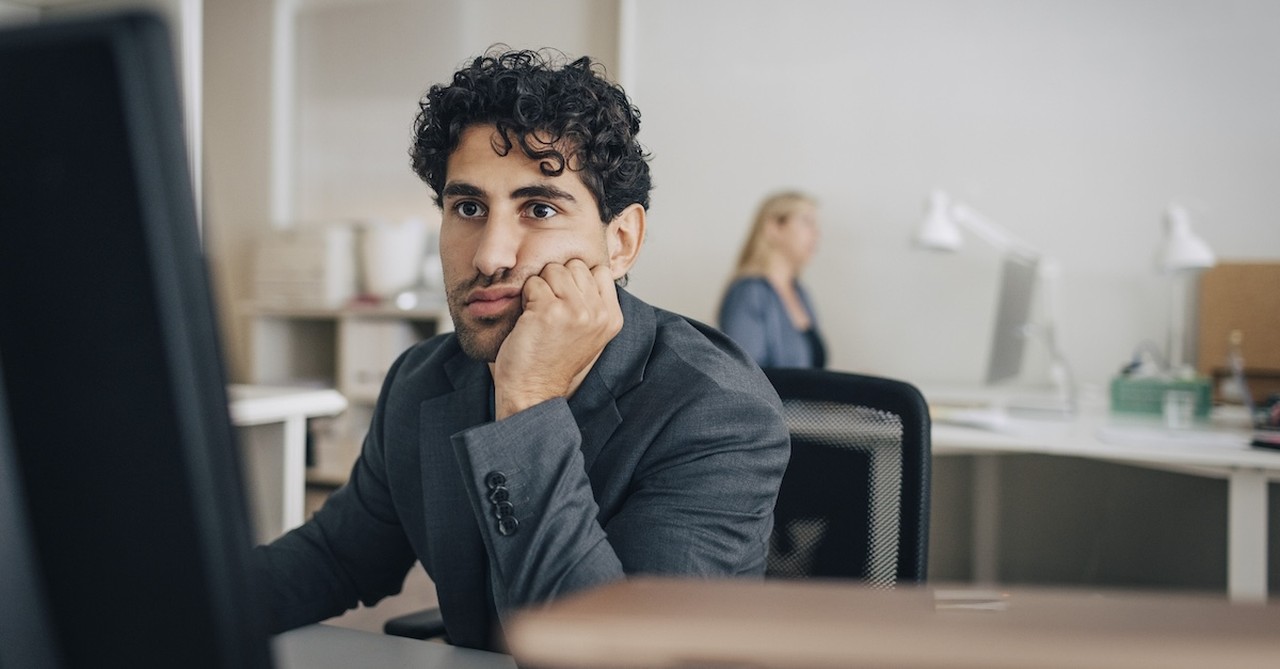 Worker at corporate office bored working job tired quitting