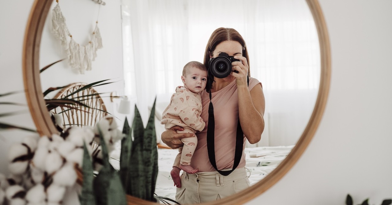 Mom postpartum with baby picture in mirror