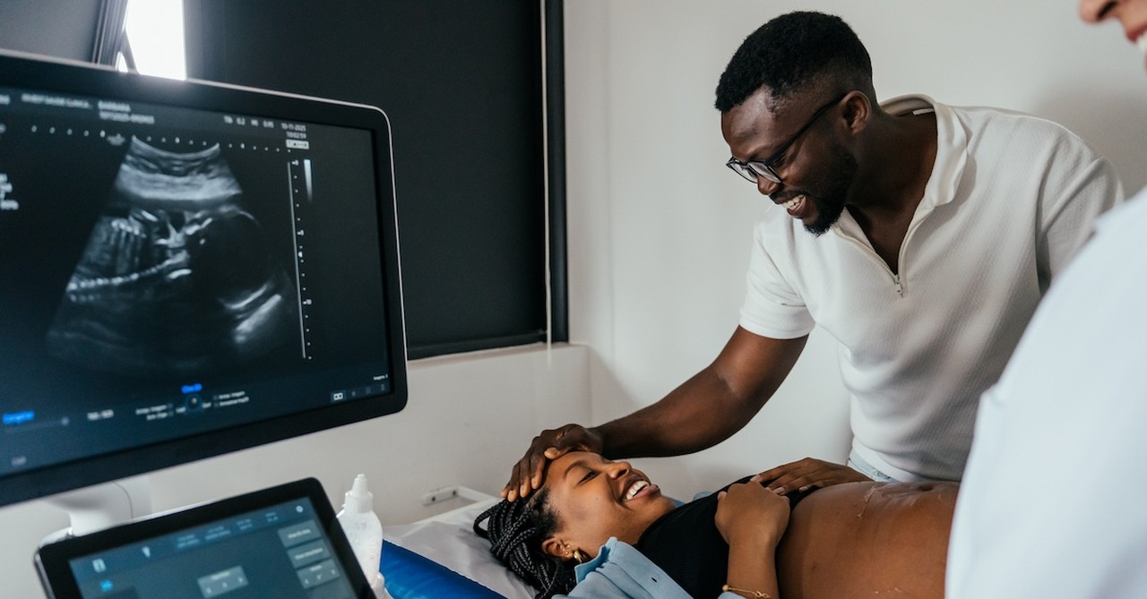 Couple at hospital ultrasound pregnancy appointment new parents pregnant