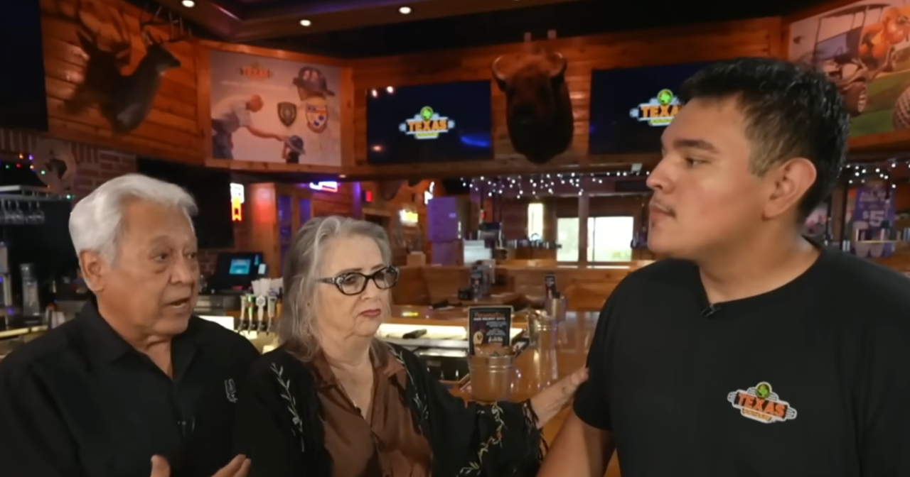 a young man standing with an elderly couple