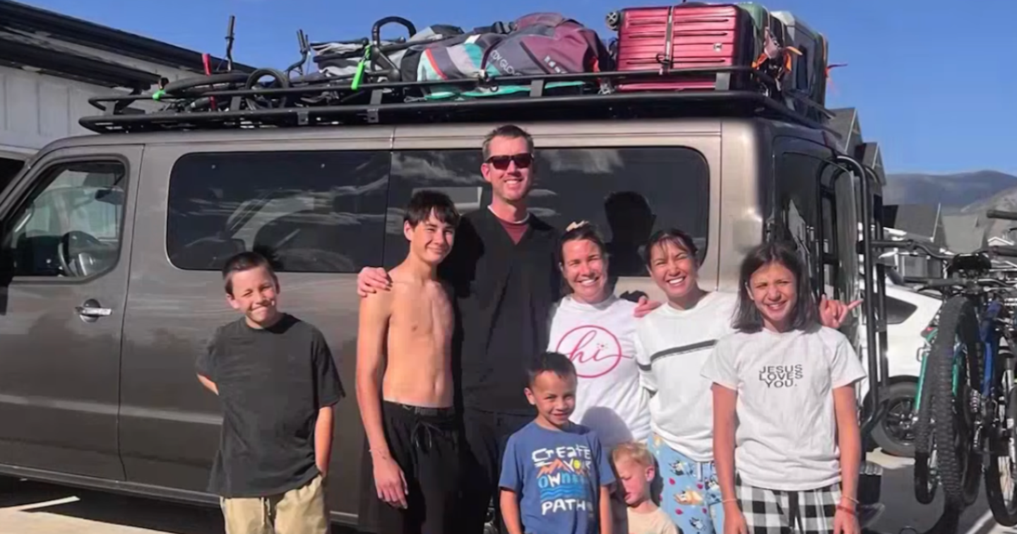 family standing in front of van