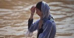 More than 20,000 Orthodox Christians Flock to Jordan River to Be Baptized