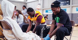 Ravens Players Model Jesus’ Servant Leadership by Washing Schoolchildren’s Feet